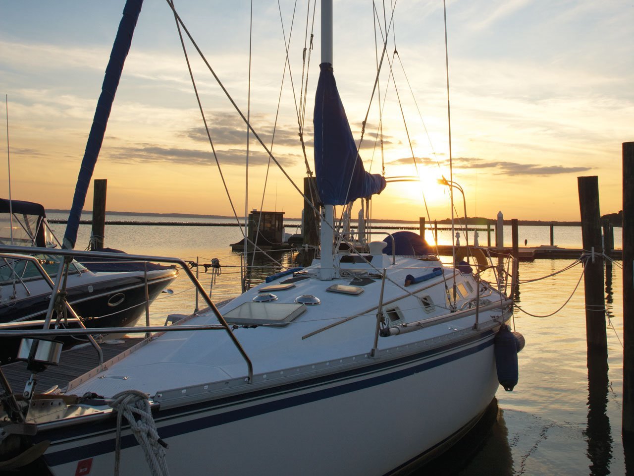 A boat in a marina at sunset
