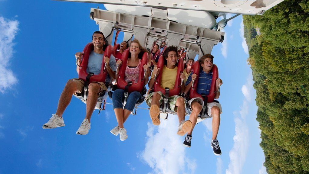 Riders enjoying a free hanging roller coaster