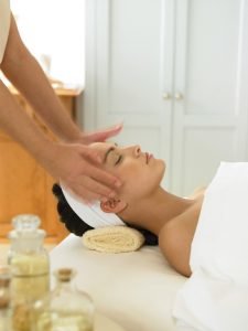 Woman on a spa table getting a facial massage