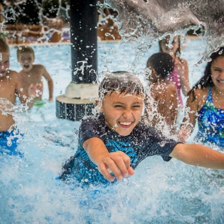 Little boy playing in a splash pool at Water Country Usa Williamsburg