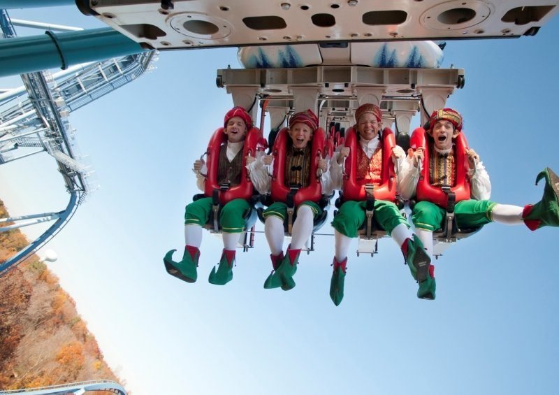 Four Christmas elves on a hanging roller coaster