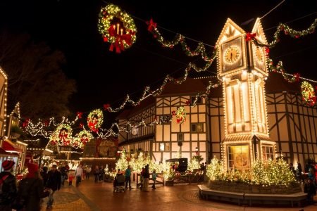 An England town at Christmastown in Williamsburg decorated with trees, wreathes, and lights