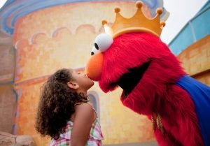 A little girl kissing Elmo on the nose at Busch Gardens