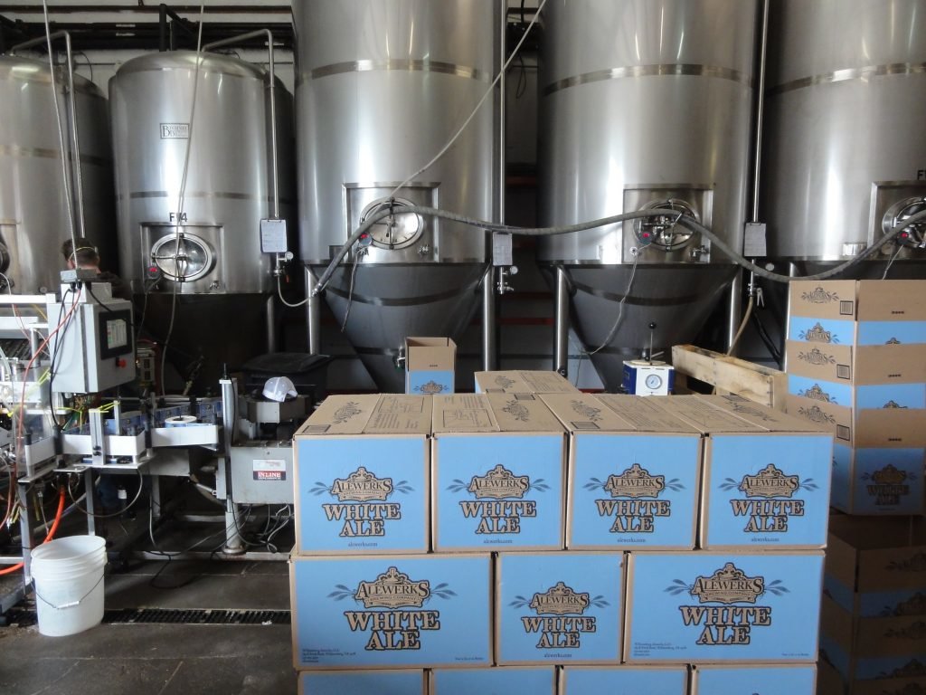 Brewery machinery with boxes of beer stacked in front